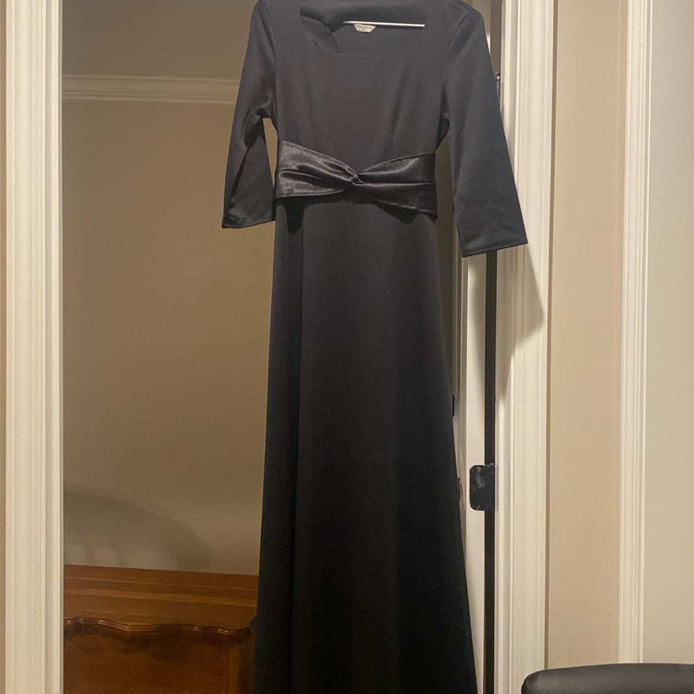 Black dress; long sleeves; empire waist.